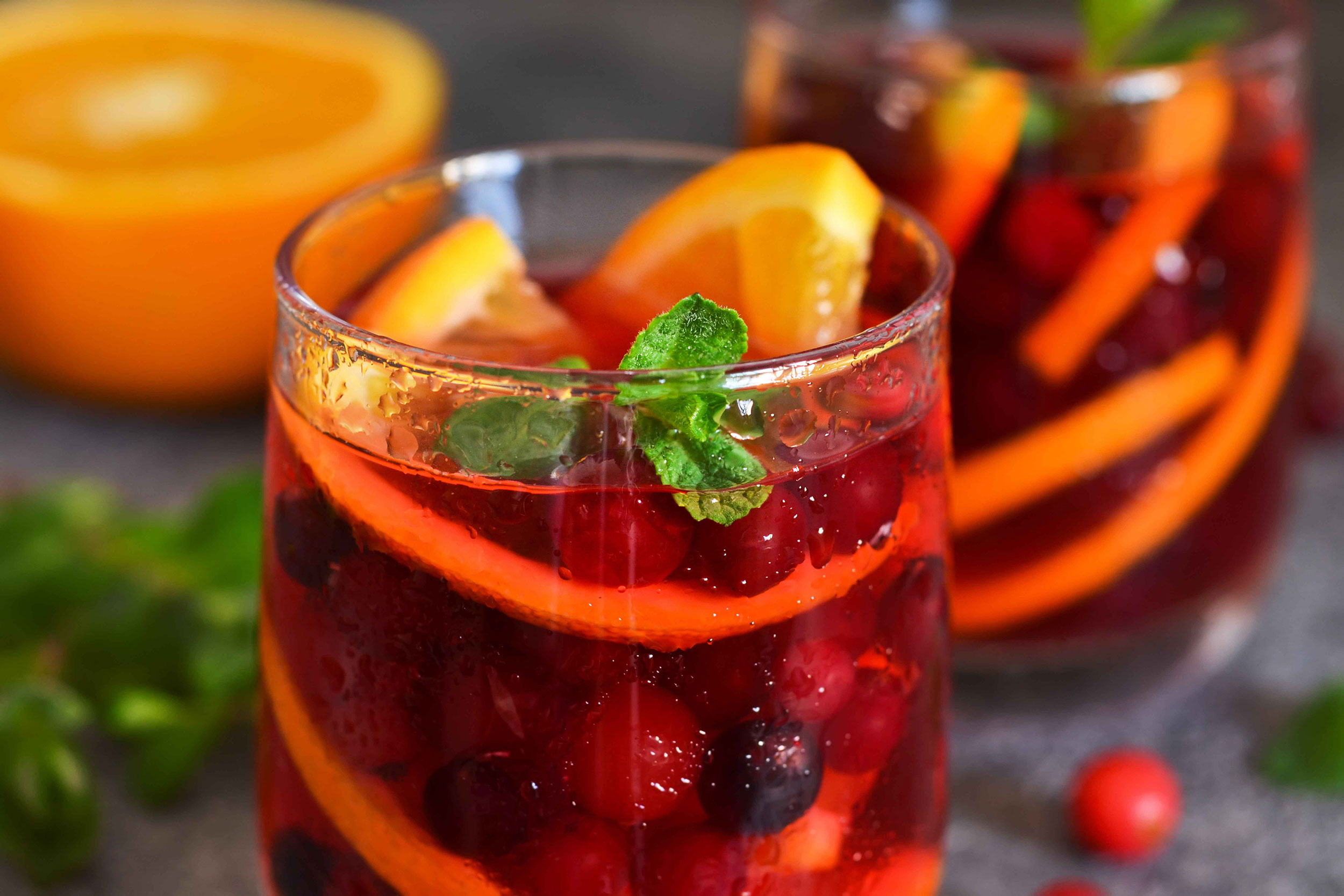 A glass filled with a fruity red cocktail