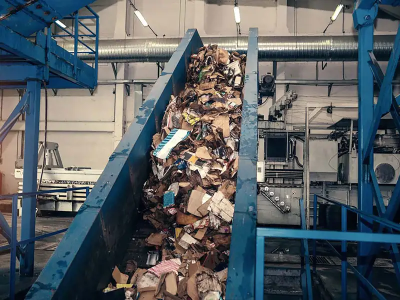 A conveyer moves waste through a processing plant