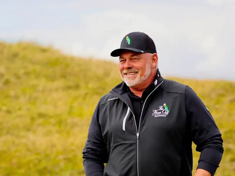 Golfer Darren Clarke talking with a friend on the golf course.
