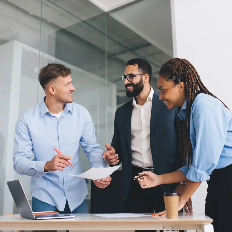 Employees chatting positively about their companies new dental insurance plan