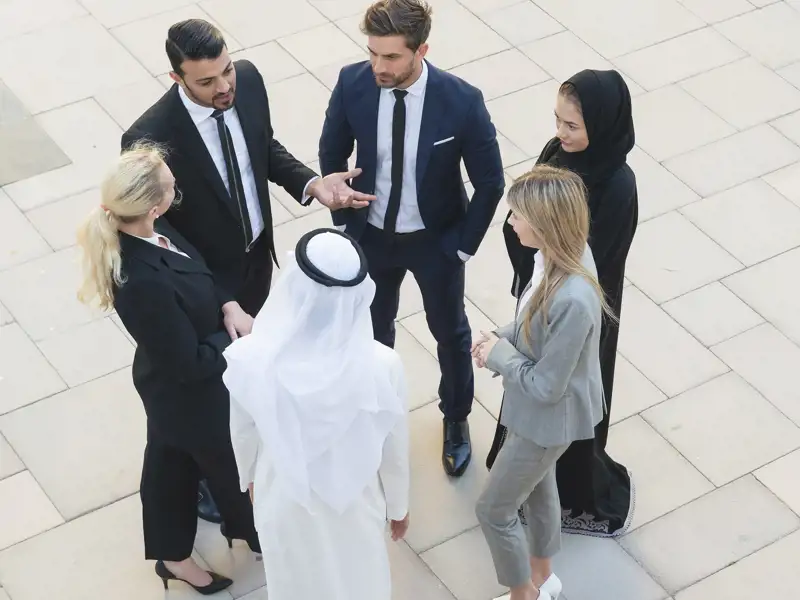 Six people from various cultures standing and talking