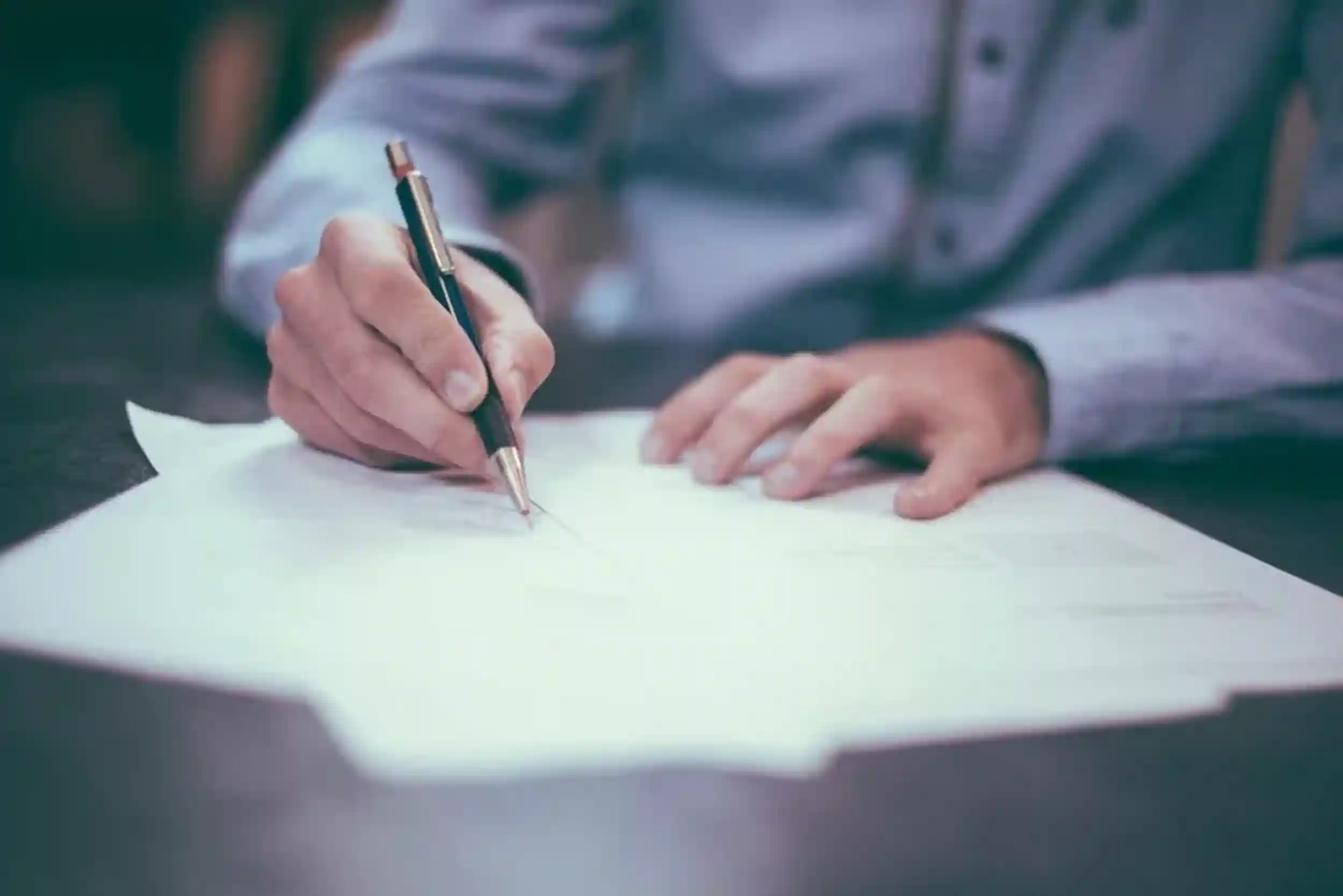 a man writing a written warning letter during a disciplinary procedure
