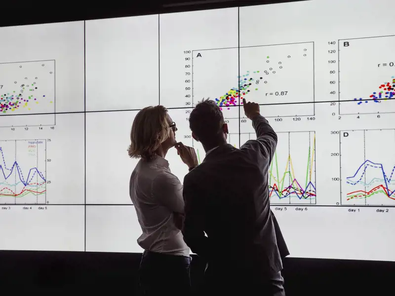 Two people looking at charts