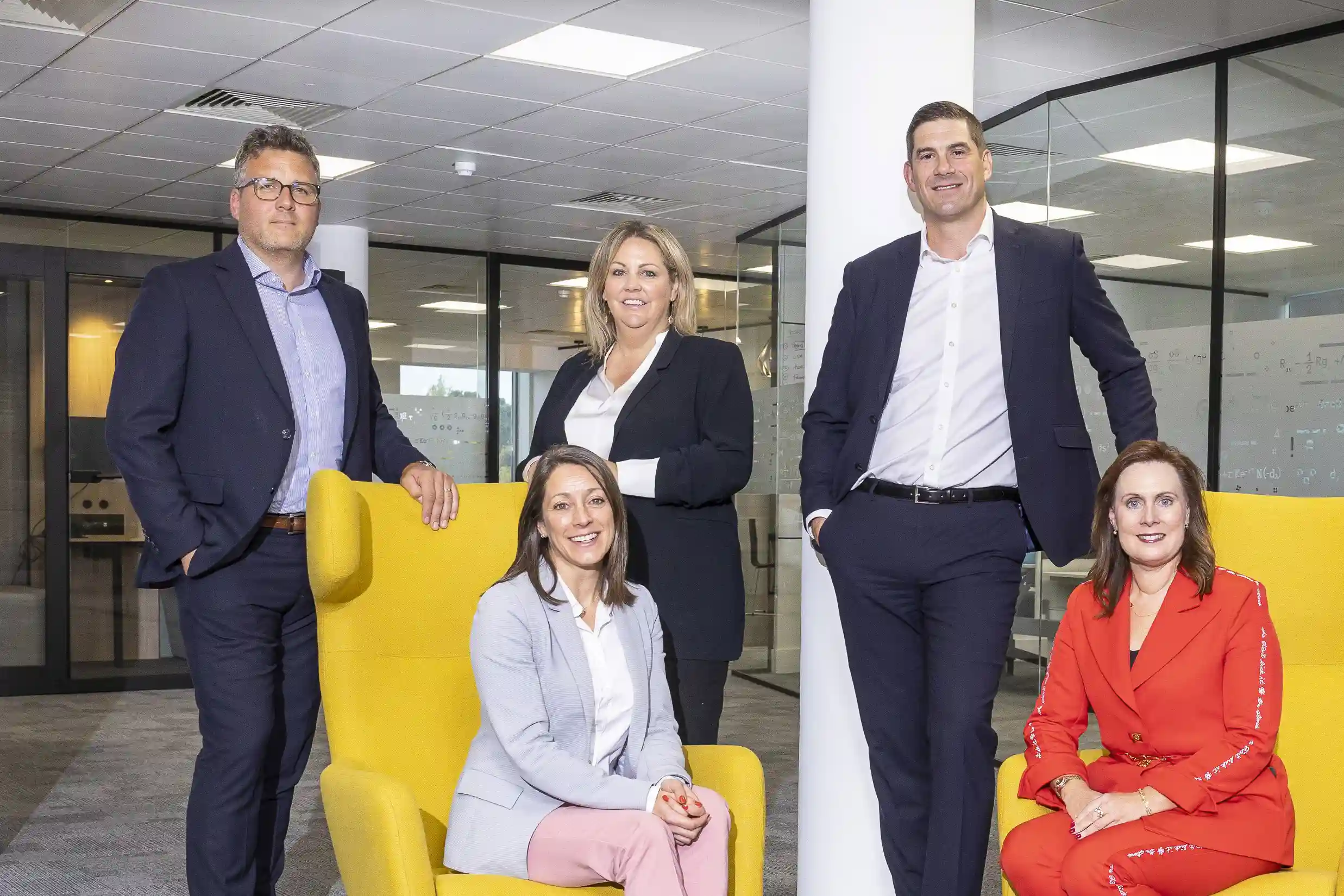 People in office posing for photo