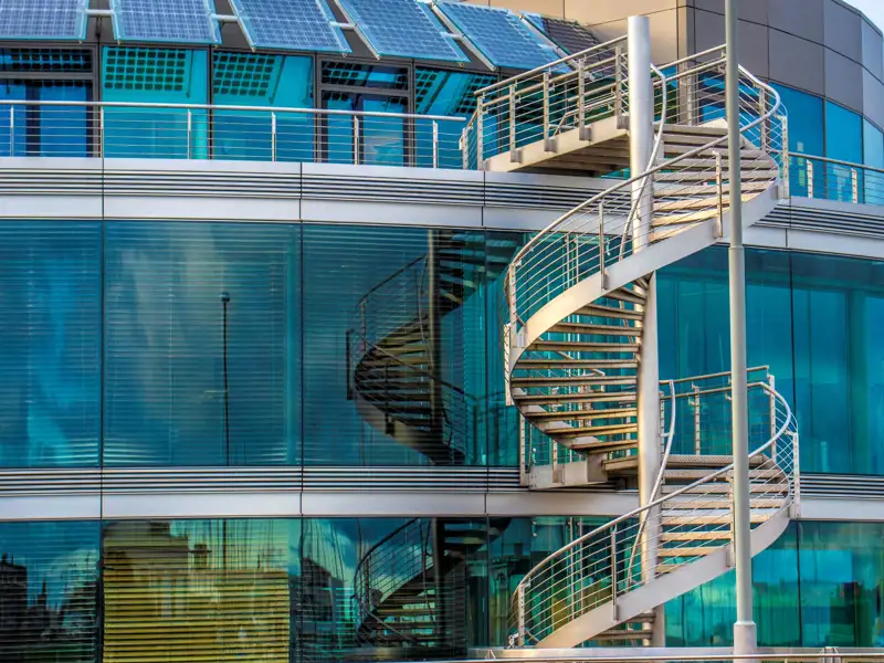 Spiral staircase outside of a modern office building.