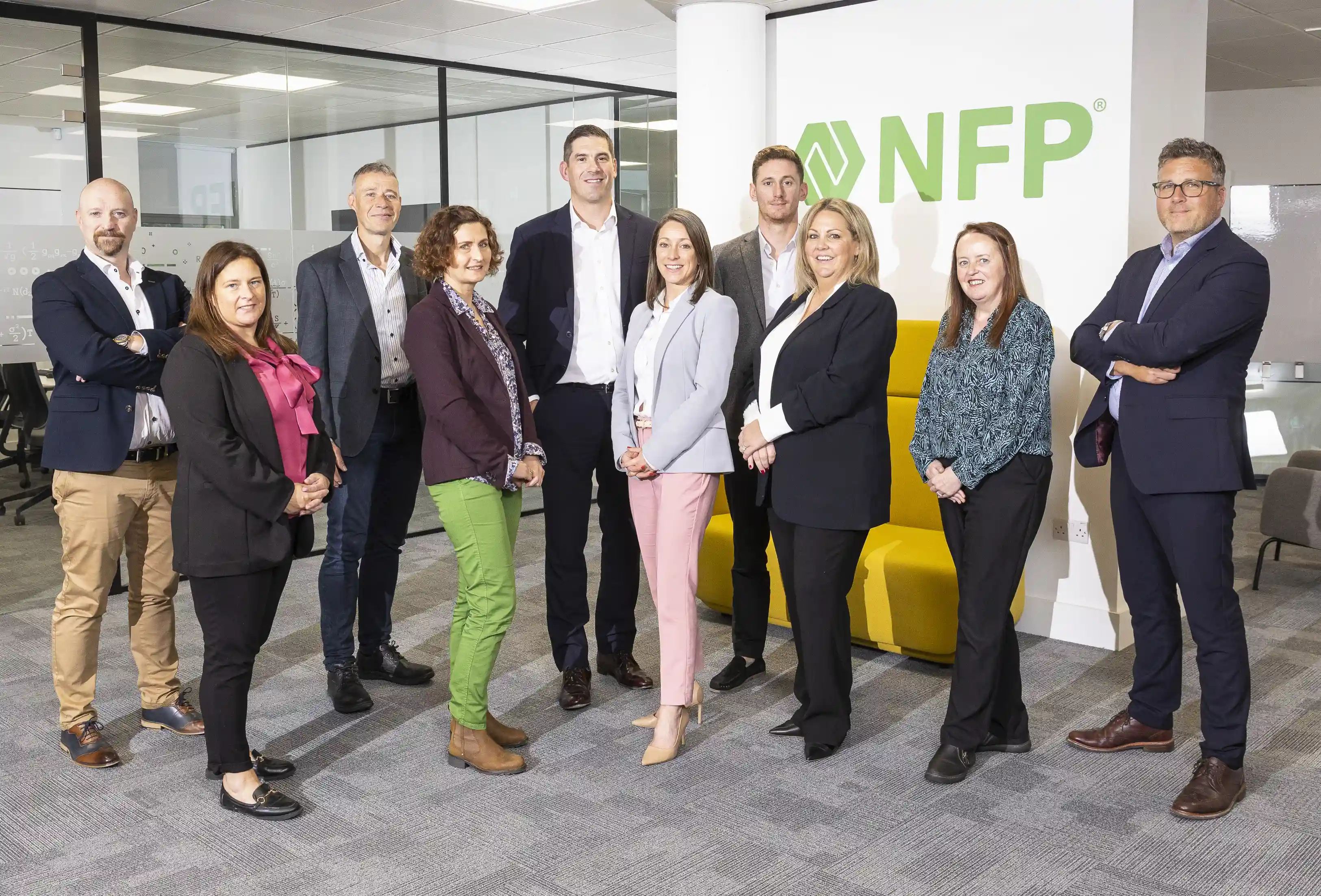 Group of people stood in front of NFP logo