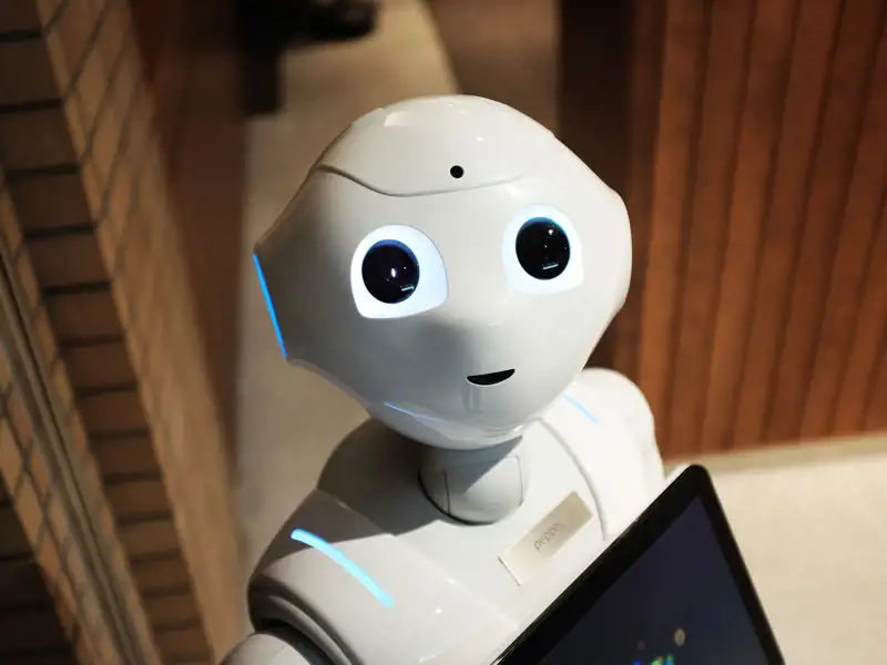 A cute robot smiles at the camera