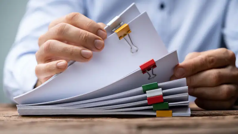 man reading through papers