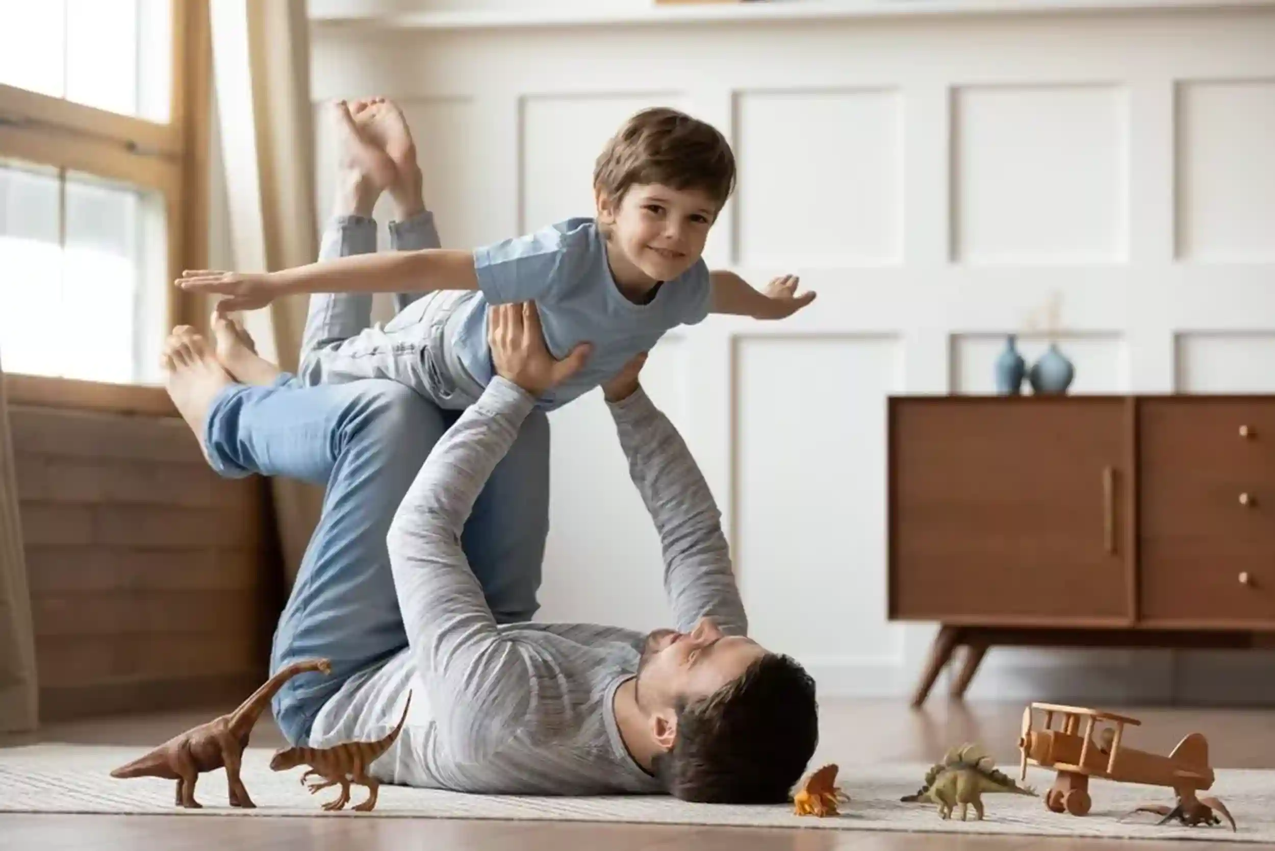 Portrait,Of,Happy,Young,Caucasian,Father,Lying,On,Floor,